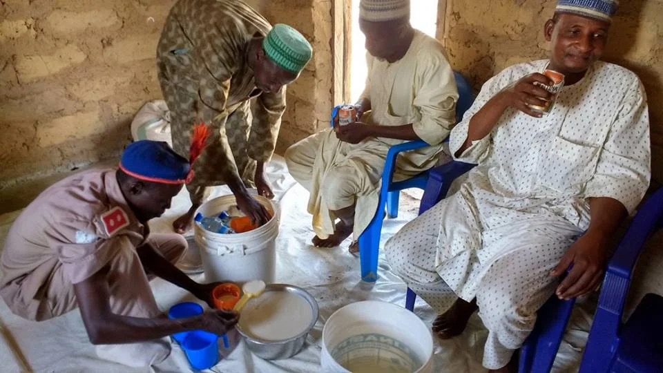  Our friends mixing 'no-no' - typical drink from sour milk and millet. Yum! 