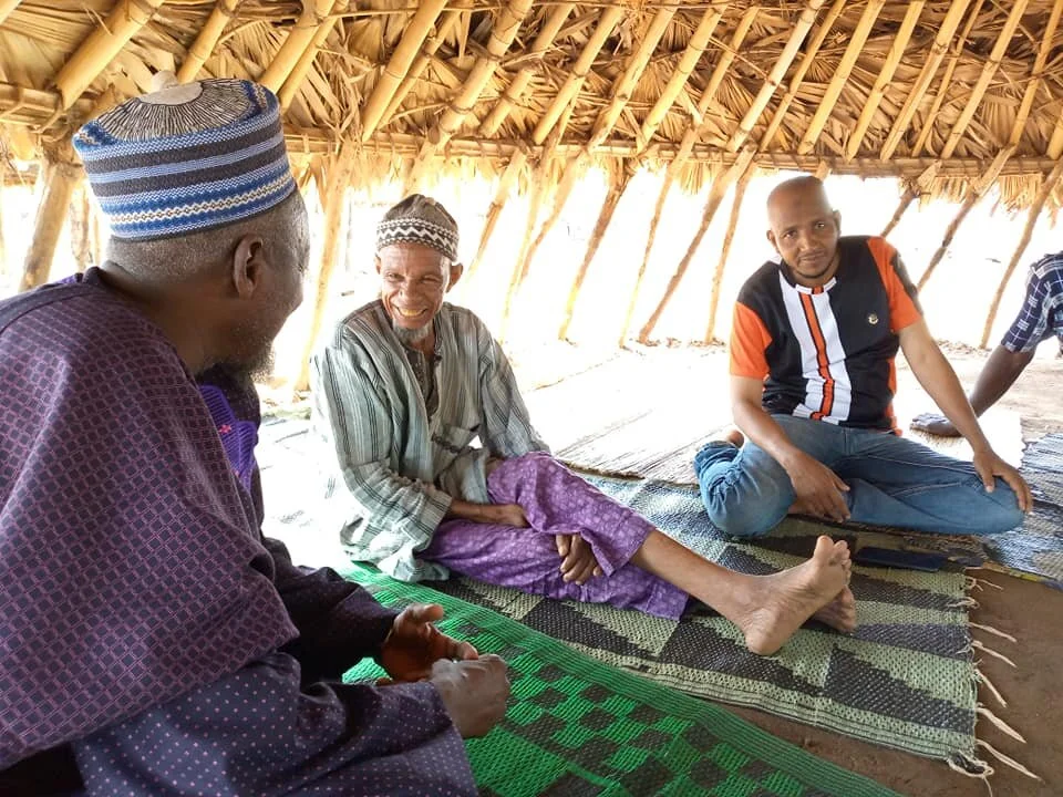  Alhaji Bature talking with the village leader, Alhaji Shehu. Haruna Ali, a Fulani man himself, working with SFA, explained that we'd love to establish a school in their village. 