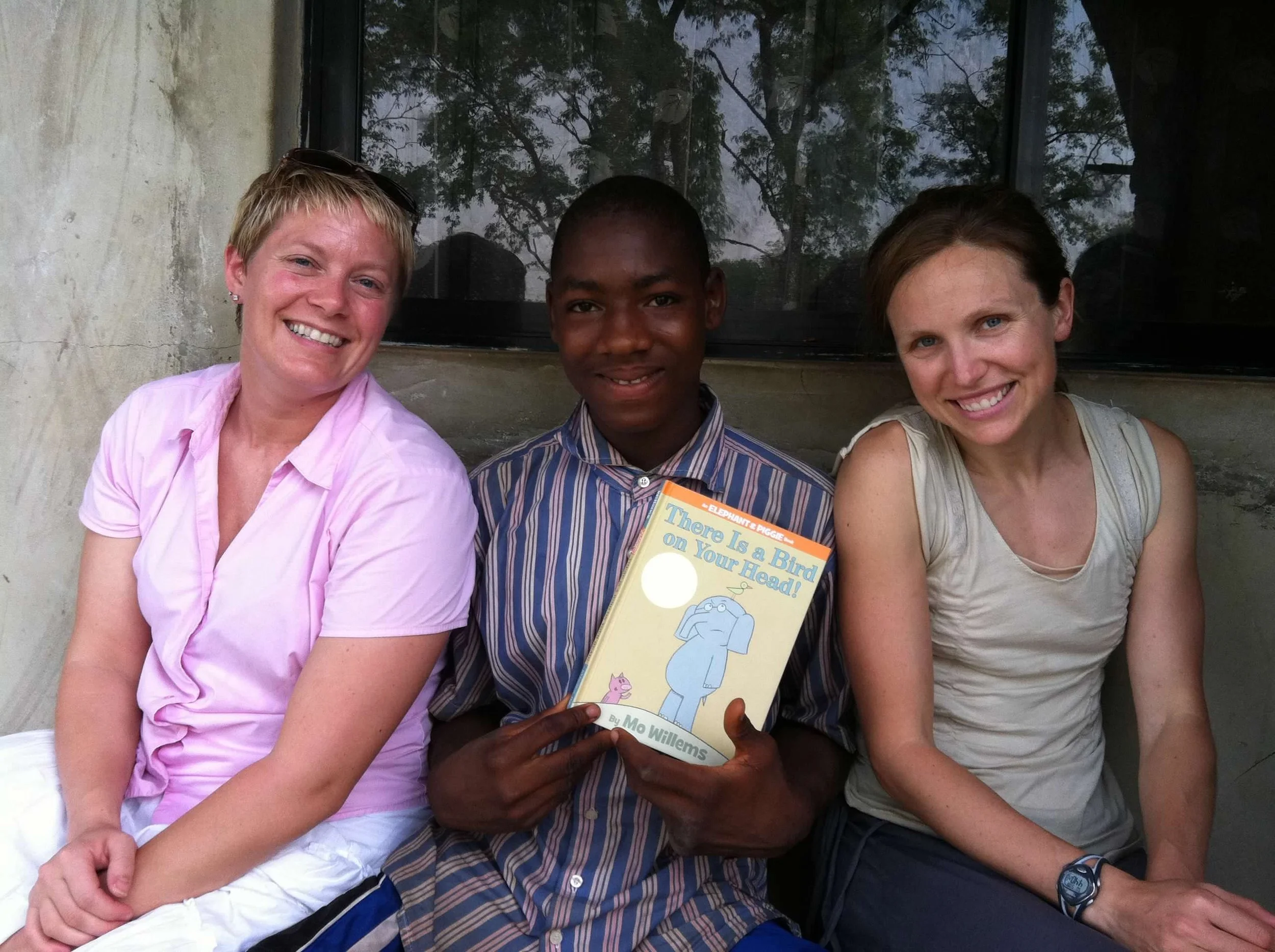  This is a pic of SFA Secretary Carisa and friend Heidi, with Salihu in 2011, practicing our reading together at Hope Academy, Emi Woro! 