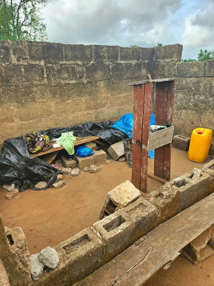  This is where Pastor Elijah sleeps. On a bench. No roof over his head. We immediately went to town, buying a mattress and having a bed made for him. Can you imagine sleeping on a narrow wooden bench for 13 years? We're also buying a pillow, supplying sheets and pillowcase, and building a small cupboard. We're setting all this up in a Friends and Neighbors classroom where Pastor will stay while his church is being built! 