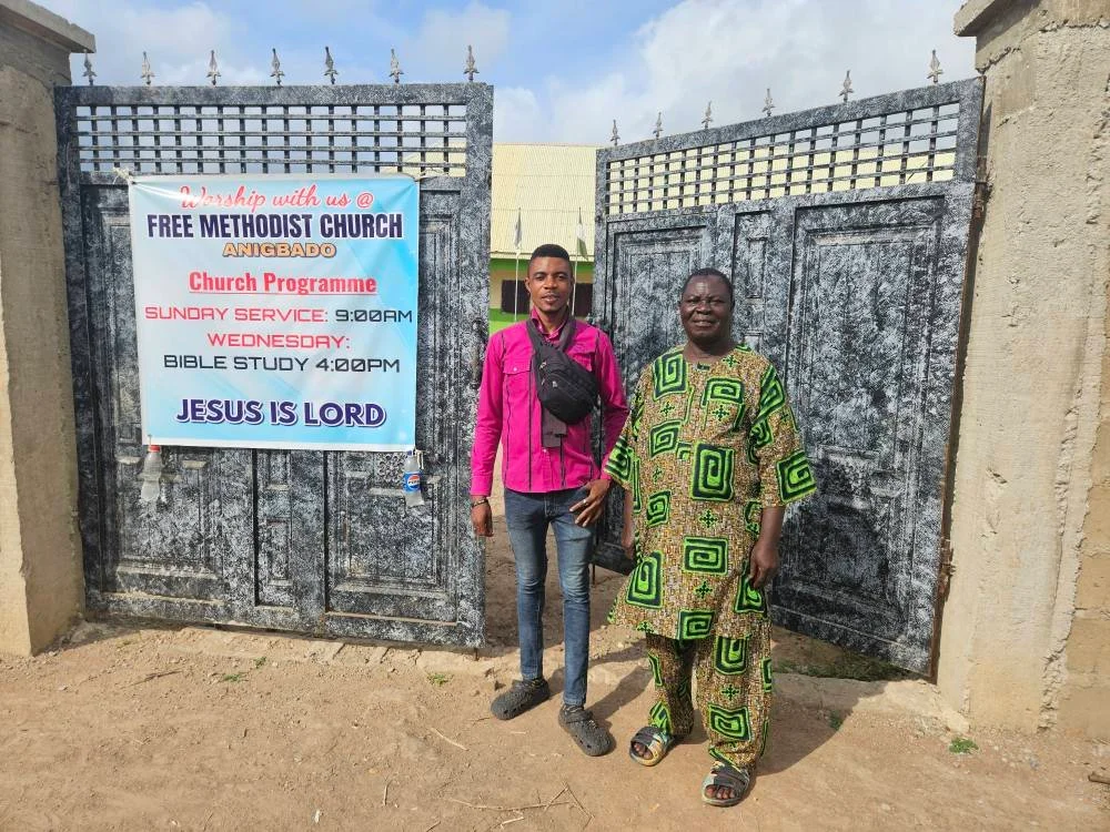  We took Pastor Elijah over to Friends and Neighbors High School, where he'll have an empty classroom to store his things and a place to sleep while we work on his little church. We will raise the walls, put a roof on his church building, INCLUDING doors, windows and floors! He and his congregation can use our church facilities here at the high school or join us in our services! Praise God! We are all so, so thankful for this opportunity to get to know Pastor Elijah and his people, and to build this church for them!!  Pastor Elijah gave his testimony today in our combined service. But before he did, he walked over to the guard house and invited our security guard to join us in church. I love this man!  Then the Pastor told his story. I want to share just one part of it. A family came to him one memorable day, carrying the body of their child who had died during the night. The family had already shaven the child's head, as is the custom, and dressed him in a white gown. They wanted Pastor Elijah to bury him.   But the Spirit of the Lord came upon Pastor Elijah, and falling on his knees, he began asking God to return this child, alive and well, to his family. He prayed and prayed, and God heard him. God answered his prayers, and raised this little boy from the dead. It happened right here, in front of many witnesses, in the small sanctuary of this little church.   And today, noticing that our security guard walked with great difficulty, Pastor Elijah laid hands on him and prayed for his healing. I believe the man will walk again! Praise God! 