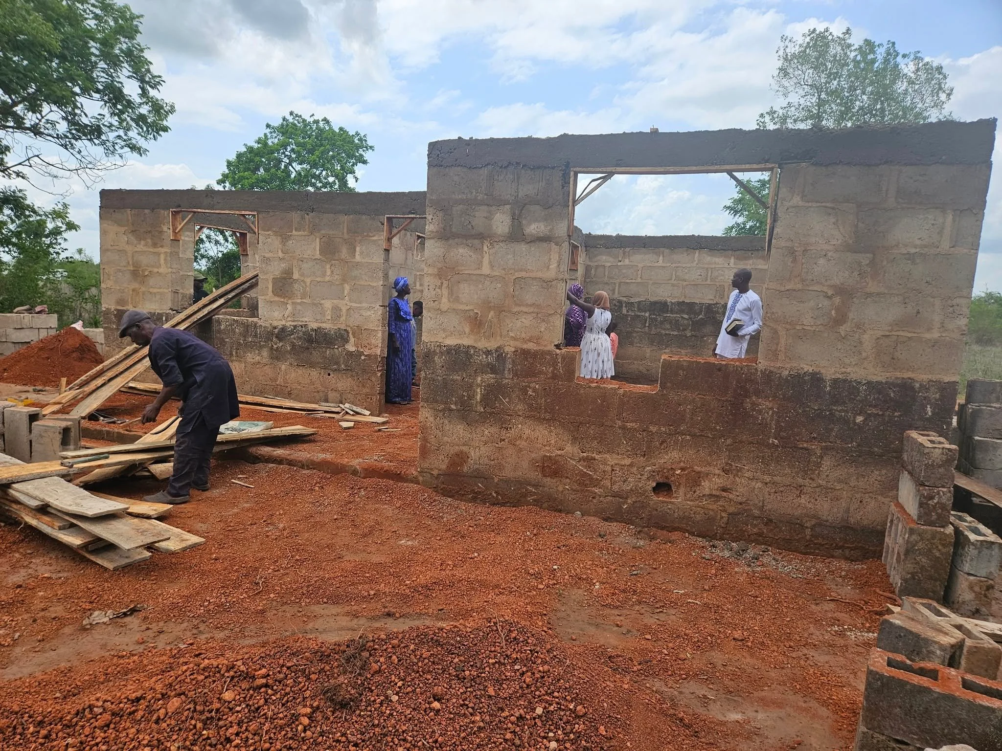  Exactly ONE WEEK after God led us to this church, we had already made some progress on the building! On Sunday, we held a wonderful combined service, with Pastor Elijah and his congregation AND our own, at the Free Methodist Church at Friends and Neighbors School. Both Pastor Elijah and Pastor Ojo conducted the service.   Afterwards, we trekked over to the church under construction and prayed for God's special favor and blessing to rest on this church, the Prophet and the congregation. What a wonderful day! 