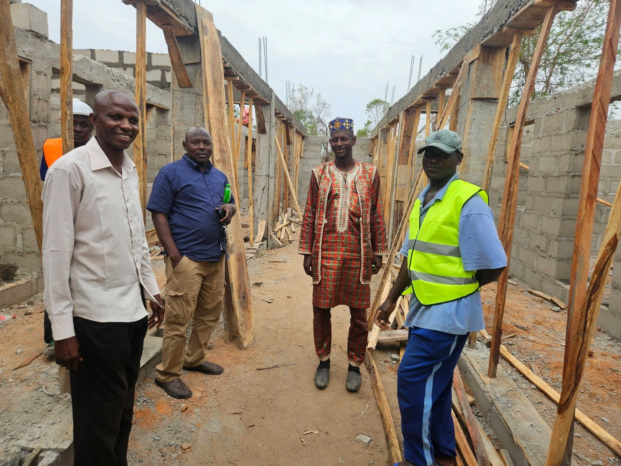  SFA Assistant Director Reverend John, SFA Manager Lawal, local chief Yusuf, and our SFA mason, Wada, inside the teachers' quarters... 