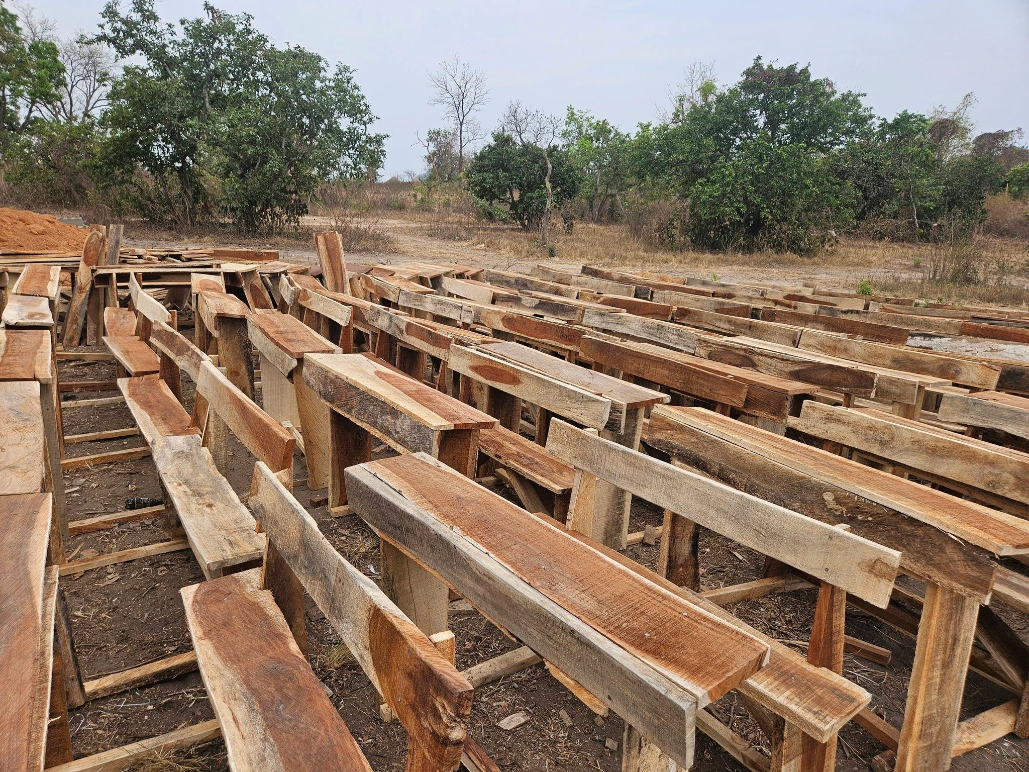  SO MANY desks! Desks are also built on-site. We haul in the lumber, and lock them away safely in a shed until school begins. 